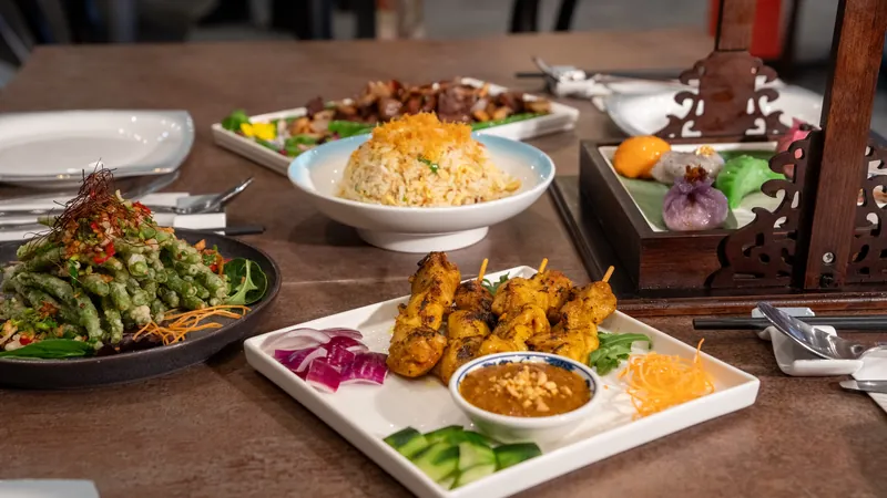Chicken satay with peanut sauce on a restaurant table