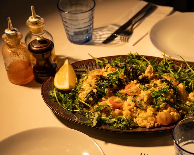 Seafood risotto menu photo with mussels and rocket